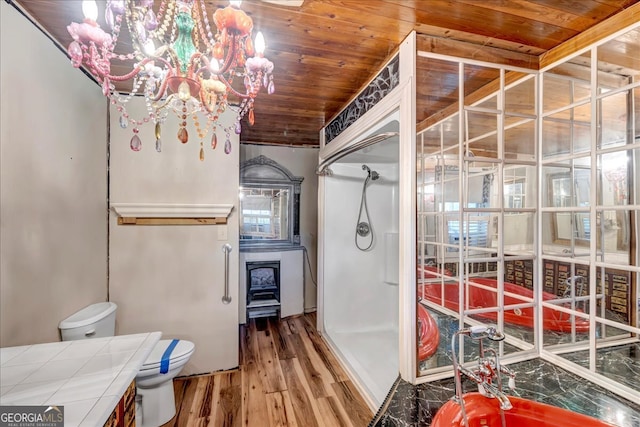 bathroom featuring toilet, wood-type flooring, an inviting chandelier, and wooden ceiling