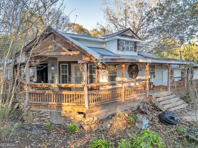 view of front of home featuring covered porch and cooling unit