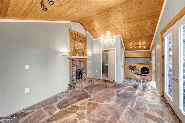 unfurnished living room featuring lofted ceiling, wooden ceiling, french doors, crown molding, and a fireplace