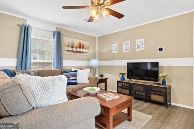 826 Shagbark Pointe Dr, Sparta, GA 31087 - living room featuring baseboards, ornamental molding, a ceiling fan, and wood finished floors