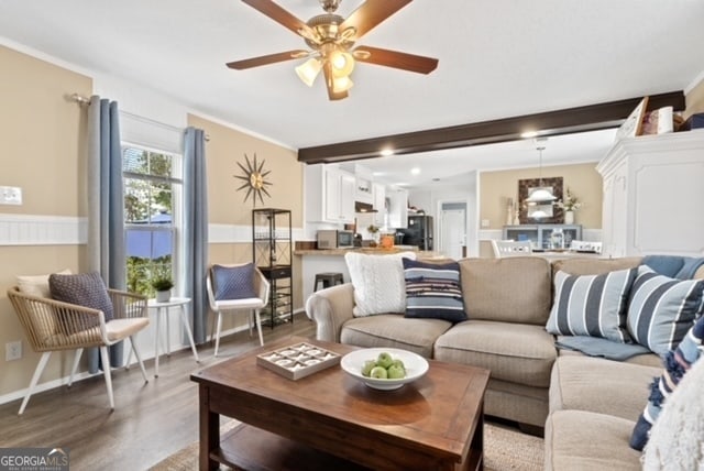 living room featuring ceiling fan, crown molding, and dark hardwood / wood-style flooring