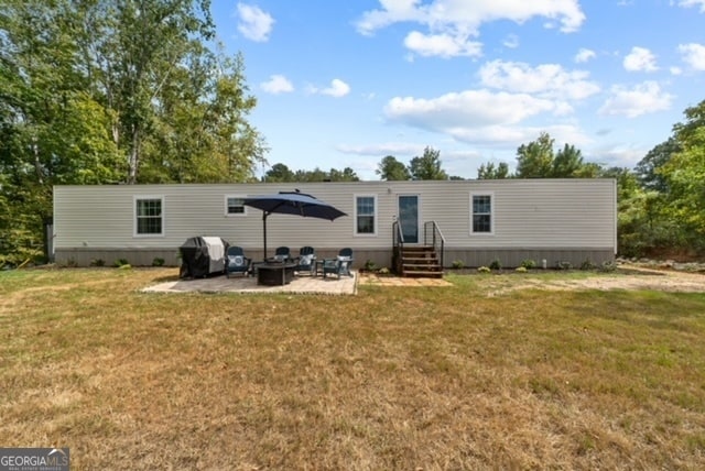 back of property featuring a yard and a patio area