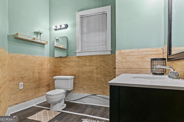 bathroom featuring wood-type flooring, vanity, and toilet