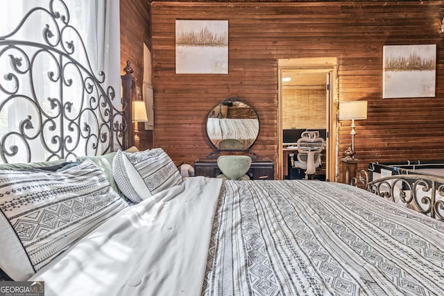 bedroom featuring wooden walls