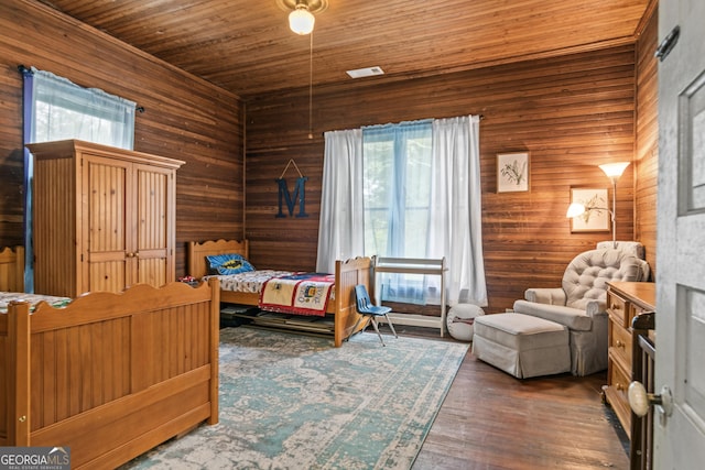 bedroom with hardwood / wood-style floors, wooden ceiling, and wood walls