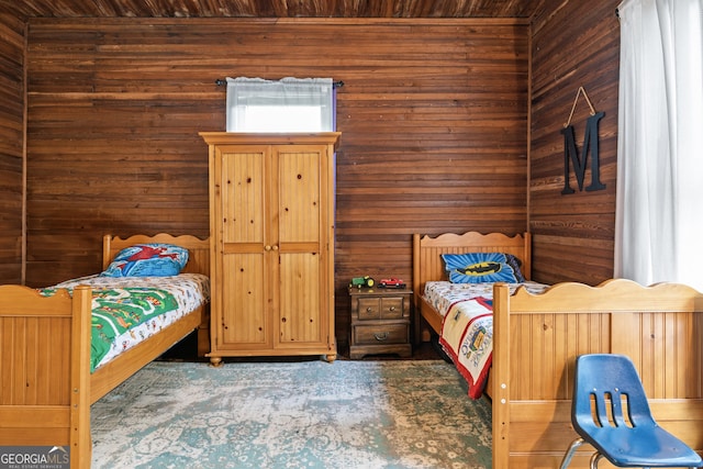 bedroom featuring wood walls