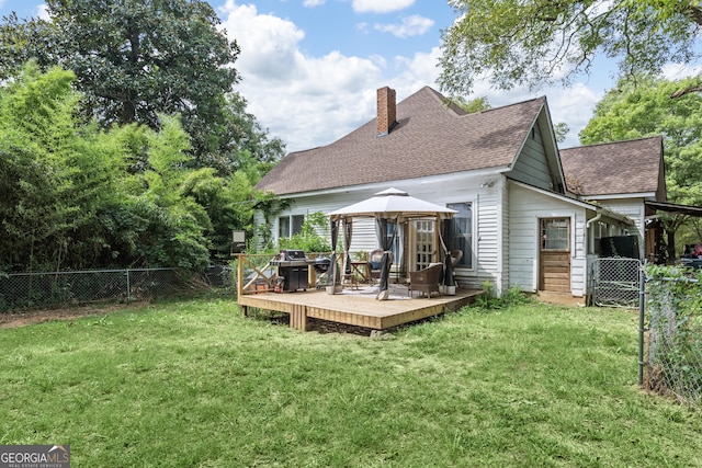 back of house with a gazebo, a lawn, and a deck