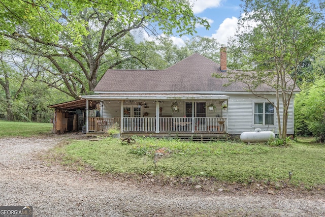 view of front of property with covered porch and a front lawn