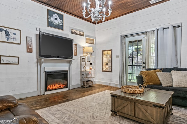 living room featuring wood-type flooring, wooden ceiling, and a chandelier