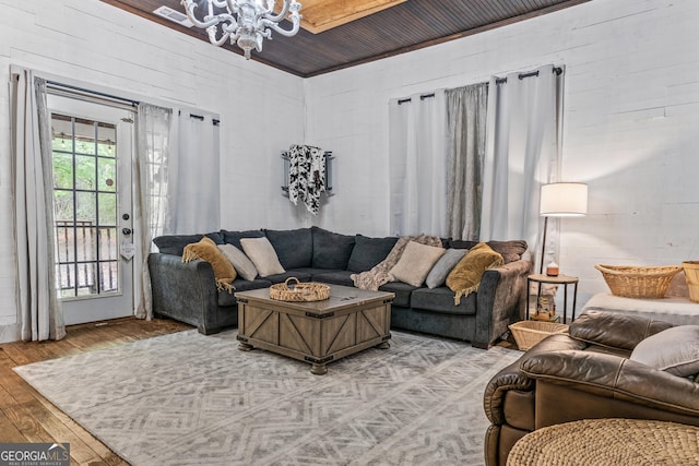 living room with wood-type flooring and a chandelier