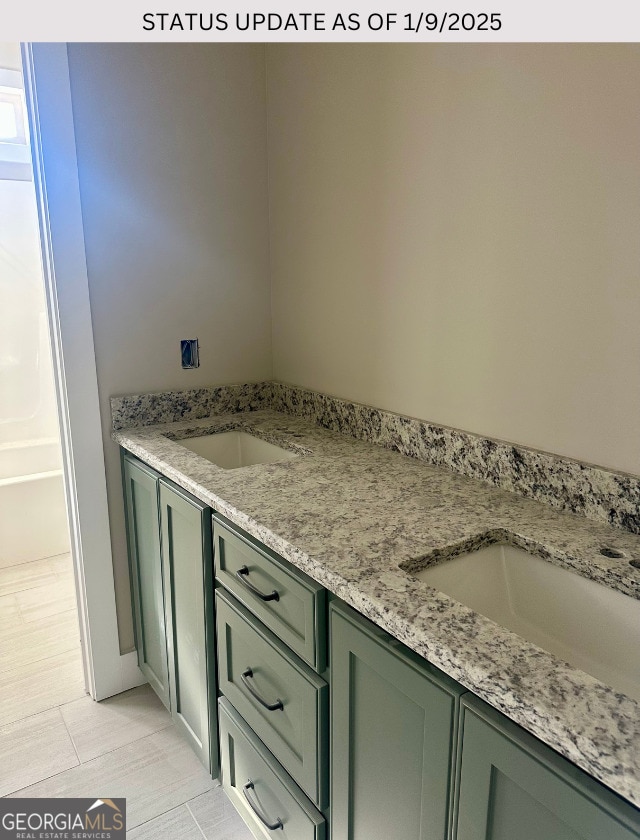 bathroom with tile patterned flooring and vanity