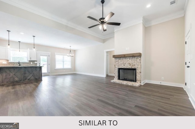 unfurnished living room with dark hardwood / wood-style flooring, ceiling fan, a fireplace, and sink