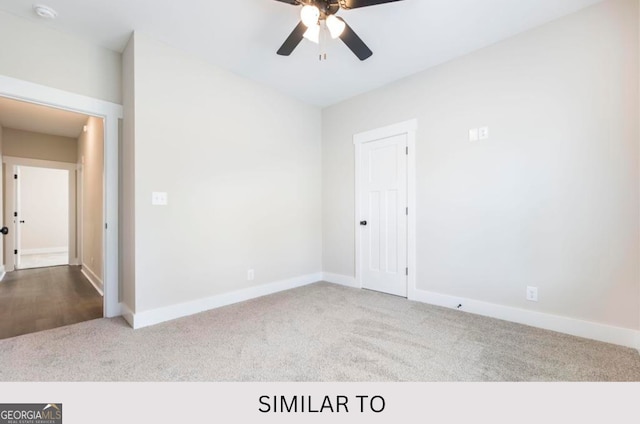 carpeted spare room featuring ceiling fan