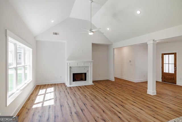 170 New High Shoals Rd, Watkinsville, GA 30677 - unfurnished living room featuring light wood-style floors, a fireplace, a ceiling fan, high vaulted ceiling, and baseboards