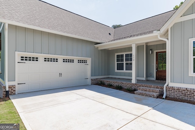 170 New High Shoals Rd, Watkinsville, GA 30677 - entrance to property with board and batten siding, driveway, roof with shingles, and an attached garage