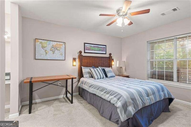 carpeted bedroom featuring a ceiling fan, baseboards, and visible vents