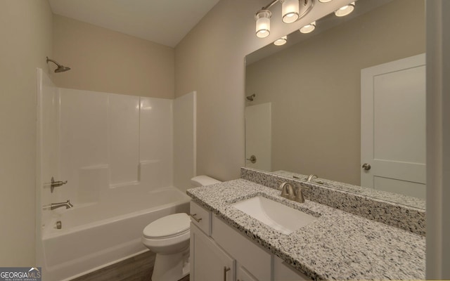 full bathroom with toilet, wood finished floors, vanity, and shower / bathtub combination