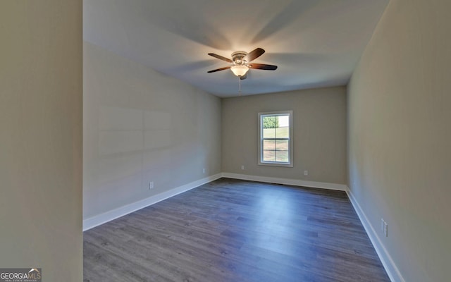 empty room with dark wood-type flooring and ceiling fan