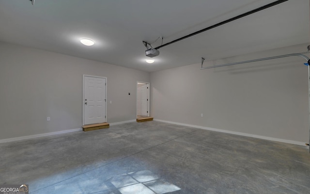 garage featuring a garage door opener and baseboards