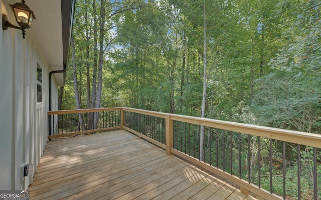 wooden terrace with a view of trees