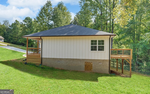 view of property exterior with a wooden deck, board and batten siding, a shingled roof, crawl space, and a yard