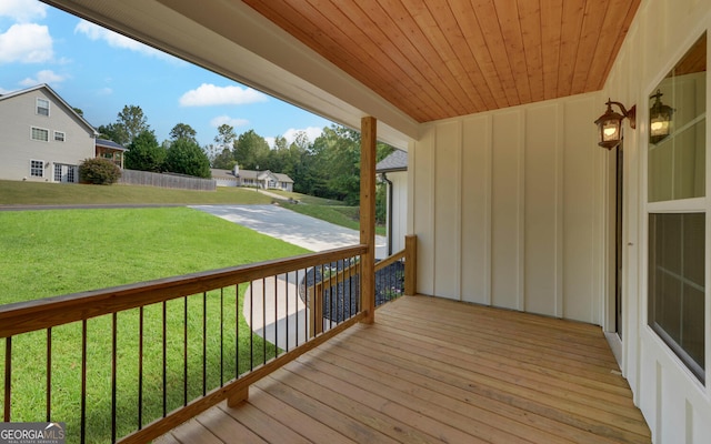 wooden terrace with a yard