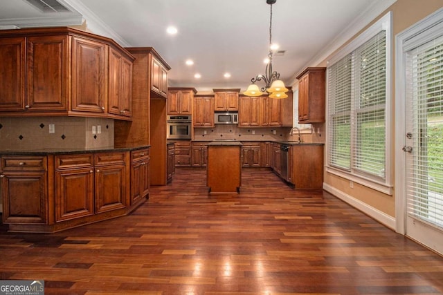 kitchen featuring pendant lighting, a chandelier, stainless steel appliances, dark hardwood / wood-style flooring, and a center island