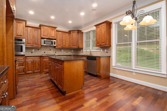 entrance foyer with crown molding, dark hardwood / wood-style flooring, and a notable chandelier