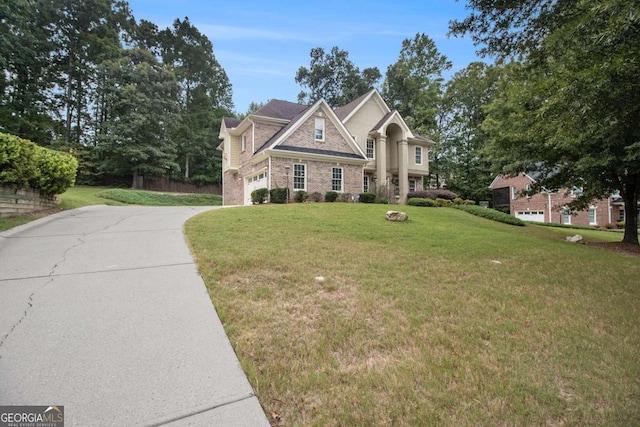 view of front of property featuring a front lawn and a garage