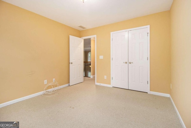 unfurnished bedroom with light colored carpet