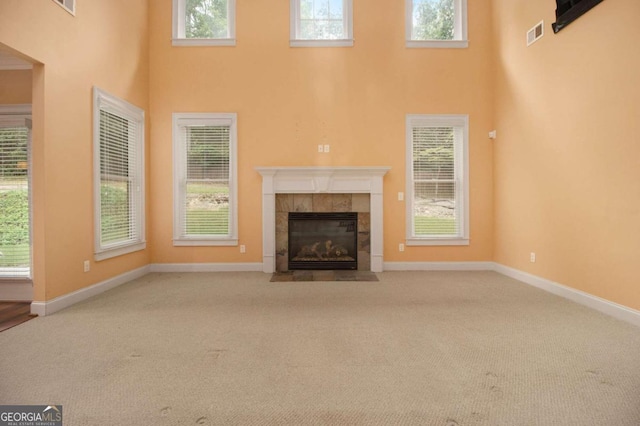 unfurnished living room featuring light carpet and a fireplace