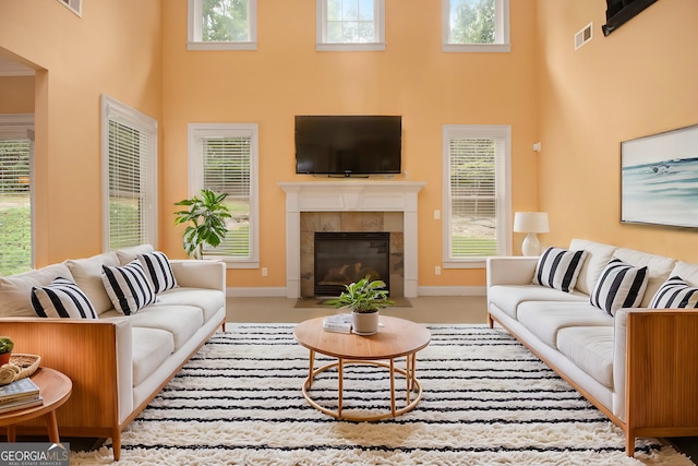 interior space with a towering ceiling, ornamental molding, and light hardwood / wood-style floors