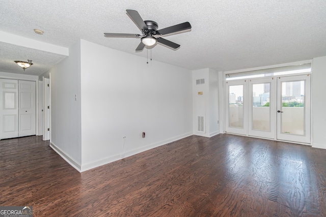 unfurnished living room featuring ceiling fan, dark hardwood / wood-style flooring, and a textured ceiling