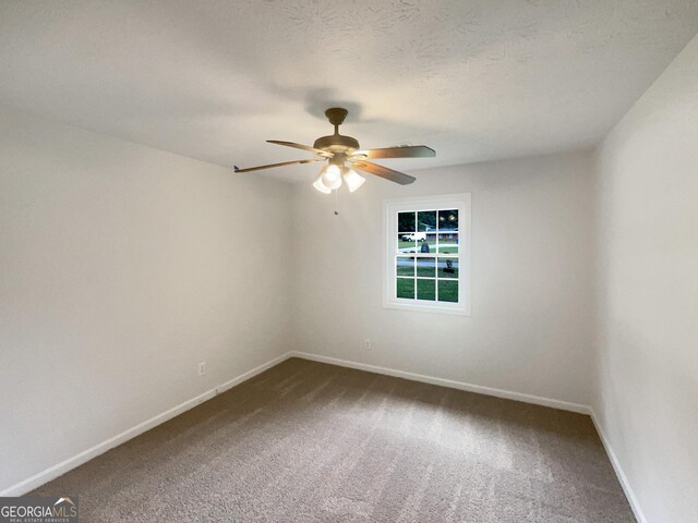 unfurnished room featuring a textured ceiling, ceiling fan, and carpet