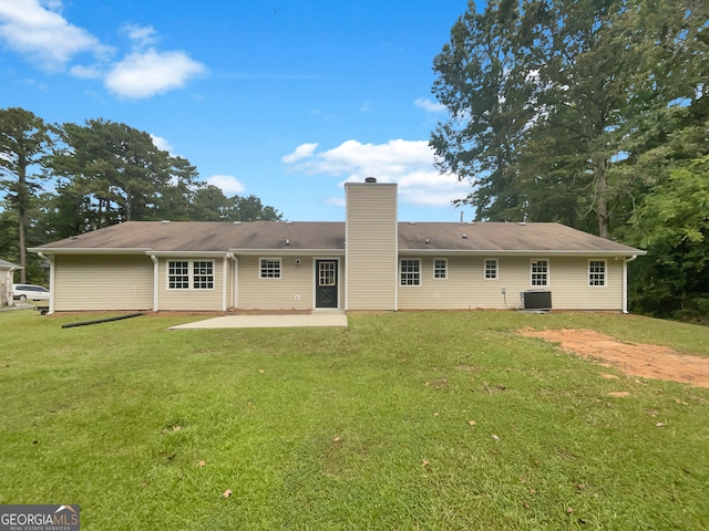 back of property with cooling unit, a yard, and a patio