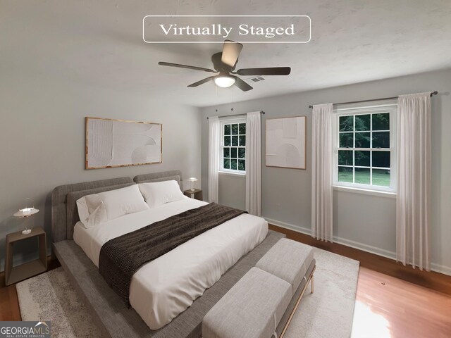 bedroom with ceiling fan and hardwood / wood-style floors