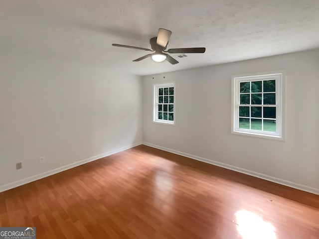 unfurnished room featuring ceiling fan and hardwood / wood-style flooring