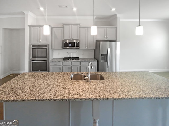 kitchen with visible vents, ornamental molding, light stone counters, appliances with stainless steel finishes, and a sink