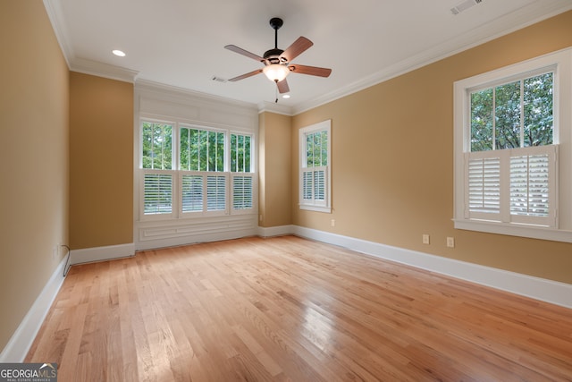 empty room featuring light wood-type flooring, ornamental molding, a healthy amount of sunlight, and ceiling fan