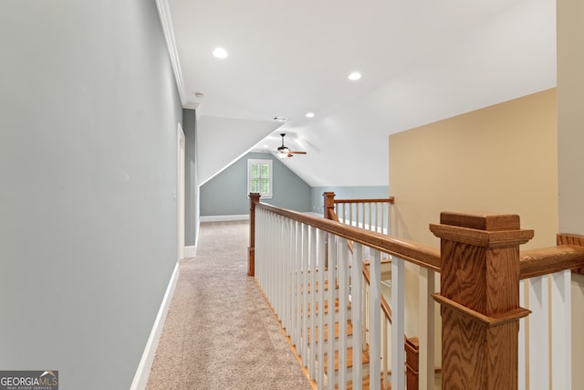 hallway with light carpet and vaulted ceiling