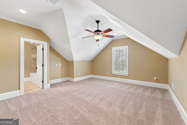 bonus room with ceiling fan, light carpet, and vaulted ceiling