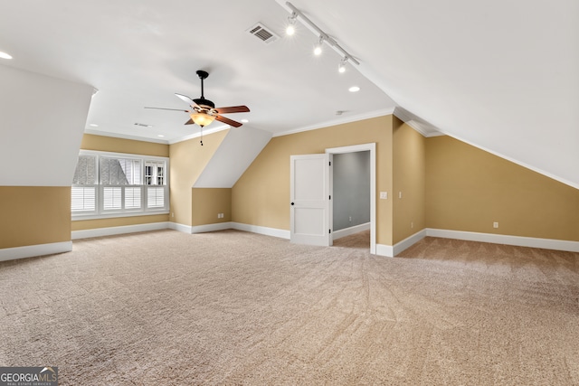 bonus room with ceiling fan, light carpet, and vaulted ceiling