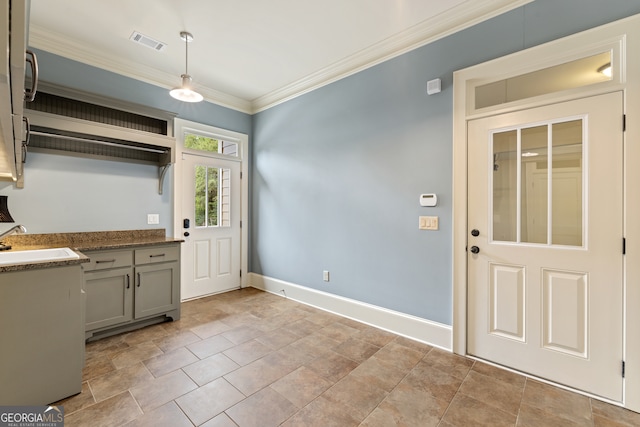 interior space with crown molding, sink, decorative light fixtures, and gray cabinetry