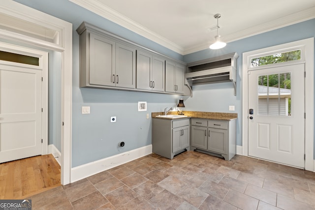 washroom with cabinets, electric dryer hookup, ornamental molding, hookup for a washing machine, and sink