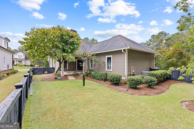 exterior space featuring a yard and central AC unit