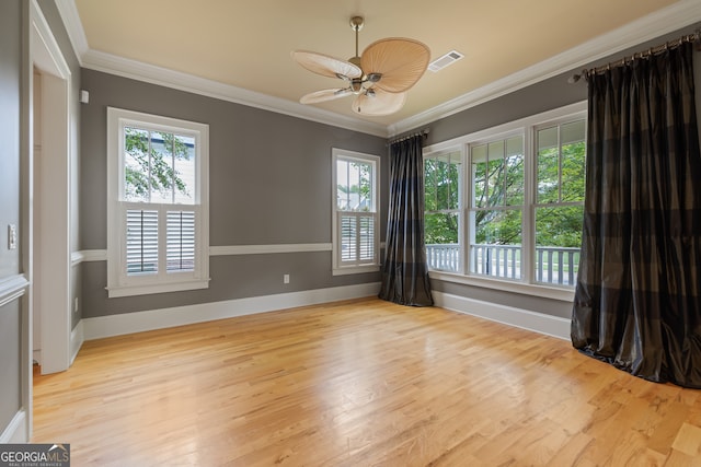 unfurnished room featuring crown molding, a healthy amount of sunlight, and light hardwood / wood-style floors