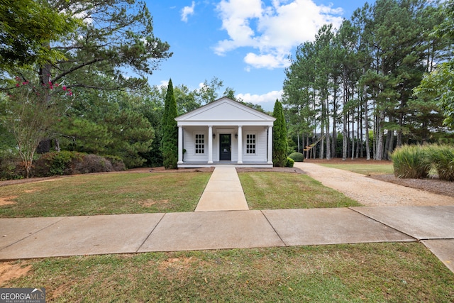 neoclassical home featuring a front lawn and a porch