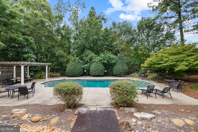 view of swimming pool featuring a patio and a pergola