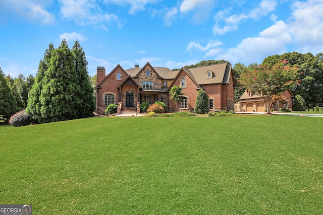 tudor home featuring a front yard