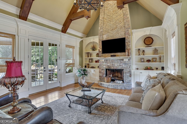 living room featuring a wealth of natural light, a stone fireplace, and high vaulted ceiling